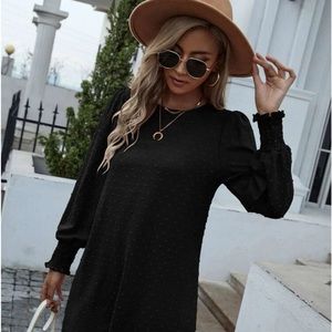 Black long sleeve dress with cuff, and dotted detailing.